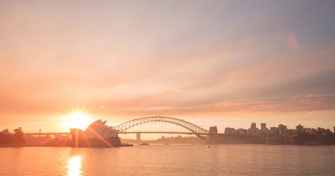 SYDNEY - AUSTRALIA - AUGUST 14: (Timelapse) A beautiful sunset over Sydney Harbour as smoke from nearby back burning creates stunning colours in the sky as day turns to night on AUGUST 14, 2017.