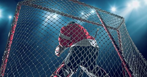 Ice Hockey goalie fails a goal on a dark background with intensional lens flares. He is wearing unbranded sports clothes.