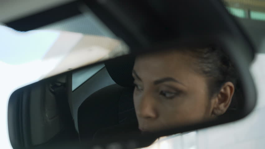 Lady sitting in car, her reflection in rear-view mirror, suspicious shady dealer Royalty-Free Stock Footage #29844271
