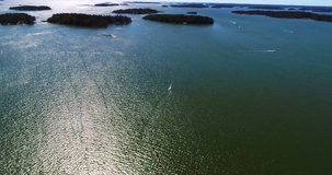 Sailboat, Cinema 4k aerial view bypassing a white sail boat, just outside lauttasaari coast, at a sunny day, in Helsinki, Uusimaa, Finland 