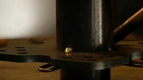 This clip begins focused on the metal pole being welded, and goes out of focus after white smoke and bunch of sparks appear in the background. Camera focuses on welding nozzle at the end.