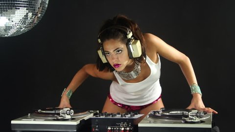 a sexy female dj dancing and playing records