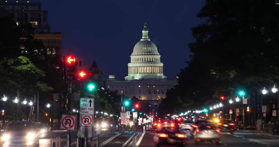 A night time lapse view of traffic activity on Pennsylvania Avenue in Washington, D.C. with the Capitol Dome in the distance.  	 Royalty-Free Stock Footage #29858257