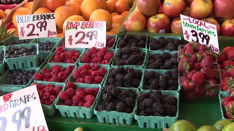 Blueberries, raspberries, strawberries and blackberries at  Market, Seattle, Washington, zoom in Stock Video