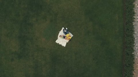 Young boy play with father on lawn, aerial shooting