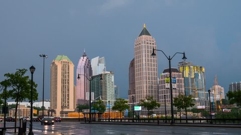 Atlanta, USA. Time-lapse of Midtown in Atlanta, USA from evening to night. Car traffic, illuminated buildings and dark sky, rain. Zoom in