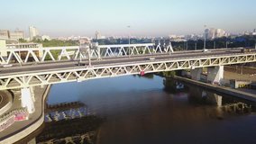 4K aerial view drone video of Moscow City area, International business center, Moscow River with bridge, skyscrapers and boats along the river in Russia on calm quiet sunny summer August morning
