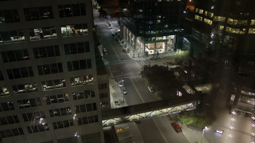 A beautiful urban night time lapse shot looking down on the streets of downtown