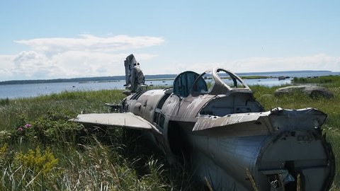 Unique video. war plane crashed on shore of sea several years ago and lies on grassy dunes