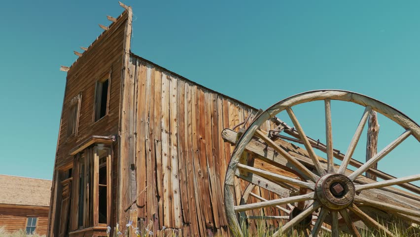 Bodie ghost town video, an abandoned countryside, decay gold wild west wooden buildings and cart, Bodie State Historic Park, California USA