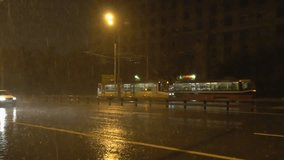 slow motion video of night traffic in a heavy downpour
