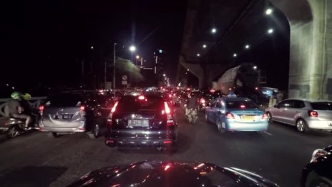 JAKARTA, Indonesia. August 14, 2017: Video footage of traffic jam on the Casablanca road with cars and motorcycle moving slowly at night