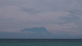View of Kinabalu mountain viewed from a distance with an ocean as the foreground