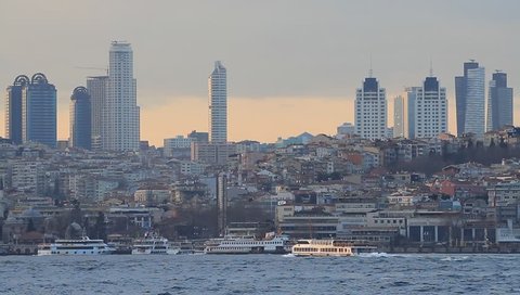 Istanbul city skyline at sunset, showing the buildings rising above Besiktas viewed from Uskudar coast
