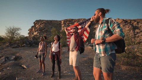 Multiracial group of people posing happily with American flag on point of destination celebrating. Video stock