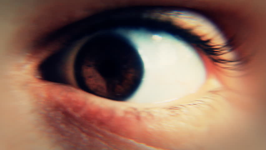 Close-up of the eye of a man awakened abruptly and having a frightened reaction,