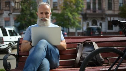 Older greyhaired man enjoying working outside
