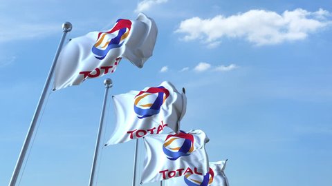 Waving flags with Total logo against sky, seamless loop. 4K editorial animation