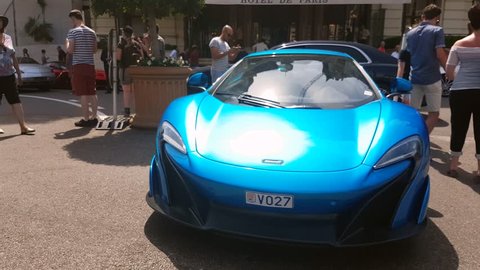 Monte-Carlo, Monaco - August 17, 2017: Beautiful Blue Supercar McLaren 650 S Parked in Front of Hotel De Paris in Monaco, French Riviera - 4K Video

