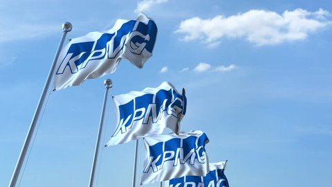 Waving flags with KPMG logo against sky, seamless loop. 4K editorial animation