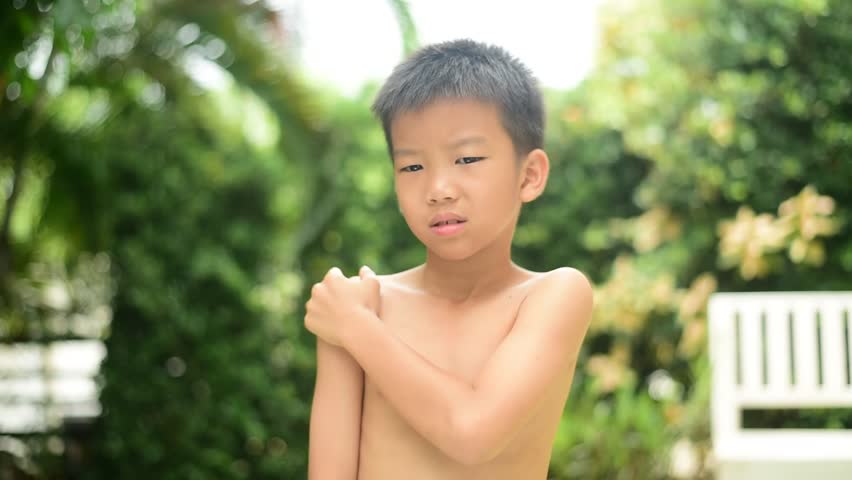 HD, 00:09 Young Asian Thai boy feel pain at his muscle at his shoulder Foot...