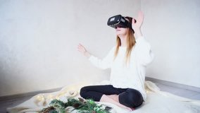 Sweet women plunged into virtual reality, using virtual reality glasses and visited virtual rides or meets other people in virtual world. Young European-looking Woman with long blond hair is dressed