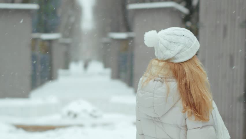 Beautiful young woman walking on a clear winter day. Winter walk