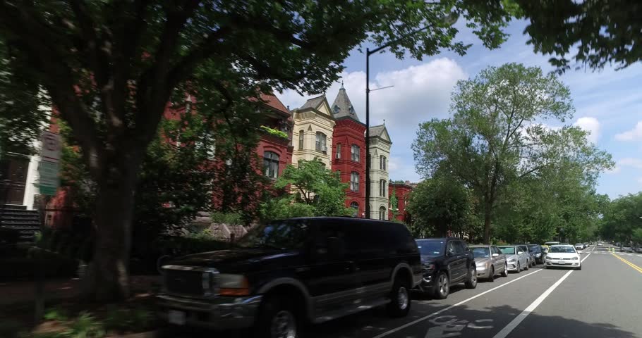 A rear profile driving perspective past typical Capitol Hill residences in Washington DC.  	
