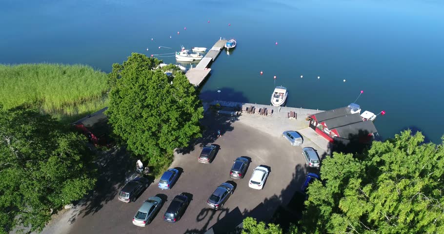 Bromarv harbour, Cinema 4k aerial landing view of the harbor in bromarv town,, on a sunny morning, in Uusimaa, Finland 