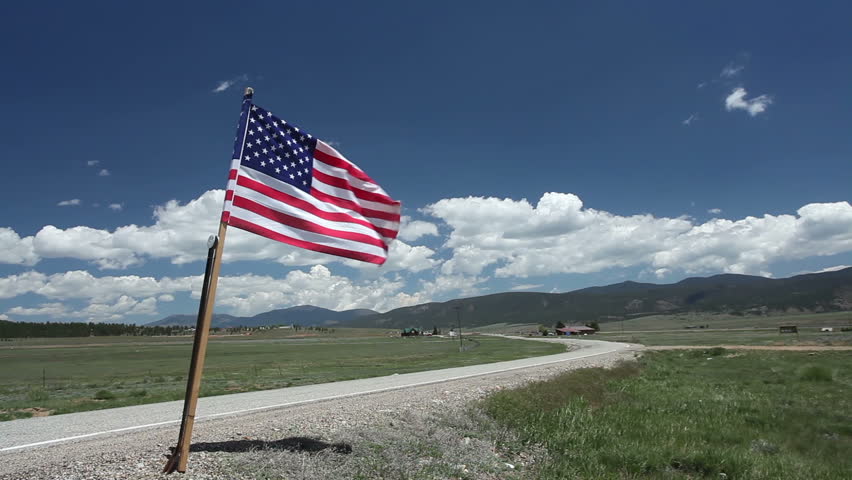 American flag on a scenic stretch of highway in New Mexico. HD 1080p.