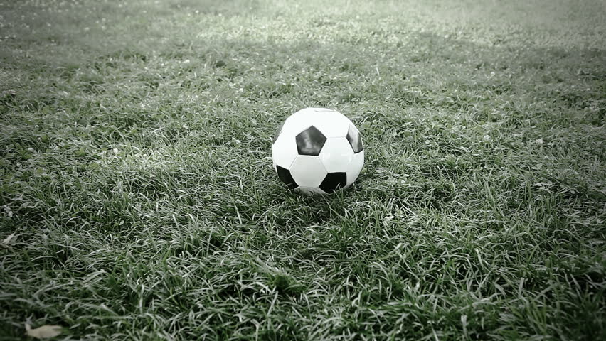 Soccer ball on the grass of football field