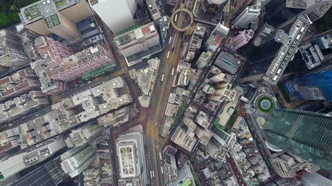 Fly along Yee Wo street, top-down aerial panorama of densely built Causeway Bay district at Hong Kong Island. Area crowded by tall towers and old houses. Densely packed urban cityscape pattern