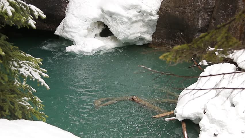 Frozen waterfall pool at Johnston Canyon