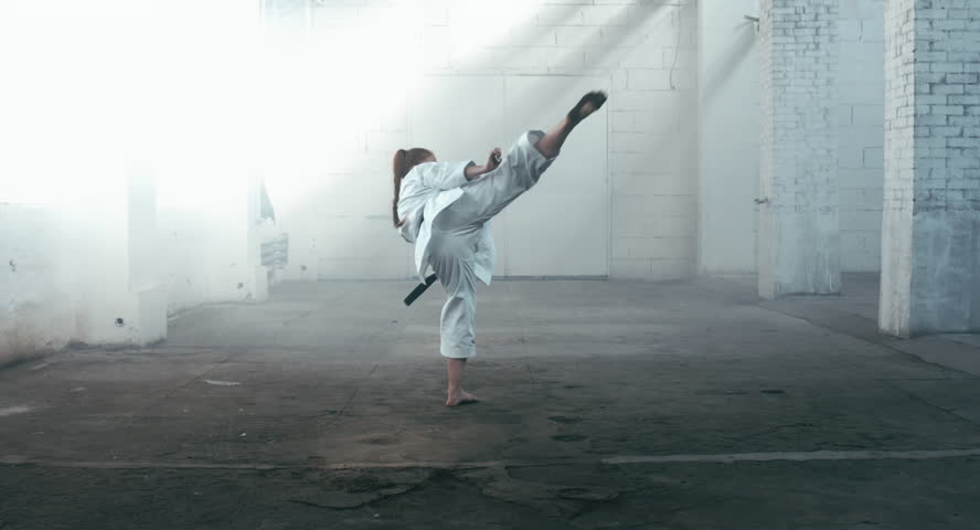 Karate girl Jump Kick stock