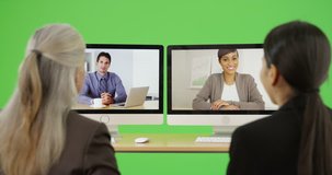 A team of office professionals have a video chat on green screen. On green screen to be keyed or composited.