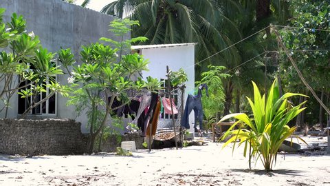 Clothes drying on rope outdoors on sun near house