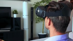 Young handsome man uses virtual reality glasses in home, in living room - closeup - Powered by Shutterstock - Get 15% off with code: PIKWIZARD15