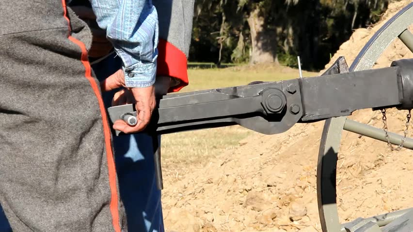Two Pairs Of Hands Attempt To Operate A Civil War Era Light Cannon Firing Mechanism