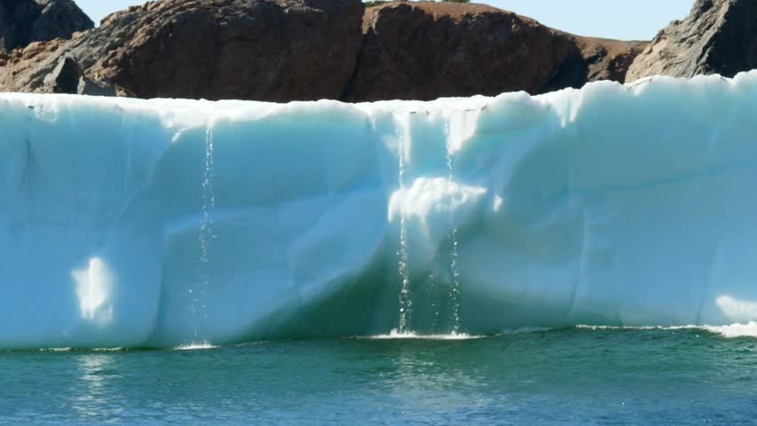 A beautiful and massive ice berg floats through the cold arctic water off the coast of Newfoundland Nova Scotia Canada