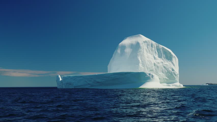 A beautiful and massive ice berg floats through the cold arctic water off the coast of Newfoundland Nova Scotia Canada
