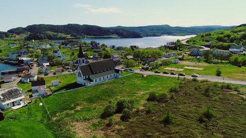 A beautiful aerial shot of a large church and historic town in Trinity Newfoundland Nova Scotia