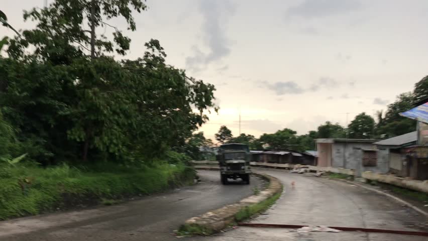 Marawi, Philippines - July 17, 2017: Military truck going by on paved road in Marawi, Philippines