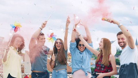 Group Of Diverse Teen Friends Cheerful Partying With Sparkler Fire In Colorful Smoke Dancing In Confetti Happy Fun Time Urban Festival Concept During Golden Hour Shot on Red Epic W 8K Slow Motion