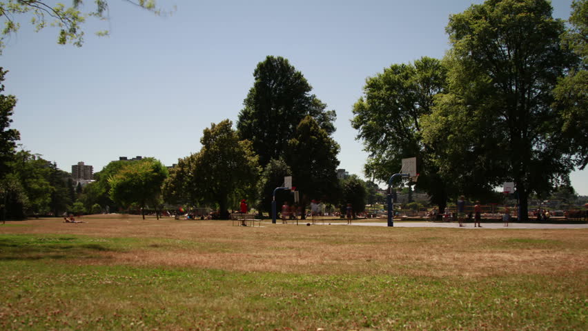 Time Lapse of People Playing Basketball by Kitsilano Beach in Vancouver. Shot in 4k RAW photo sequence