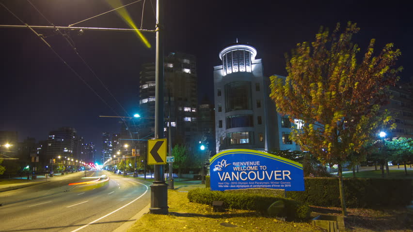 Time Lapse of Traffic on Georgia Street of Downtown Vancouver, BC, Canada. Busy Traffic coming in and out to the Lion Gate Bridge with the Welcome to Vancouver sign in the shot