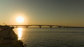 Sunrise over a road bridge across the Volga river, Russia. The bridge between the cities of Saratov and Engels. Summer morning. Footage clip 4k