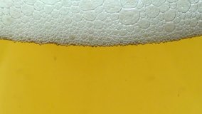 Close-up of beer and bubbles of foam in a glass. Full HD 1920x1080 Video Clip