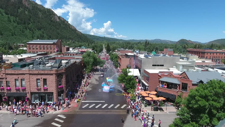 Drone flies above Independence Day Parade in Aspen, Colorado in Summer