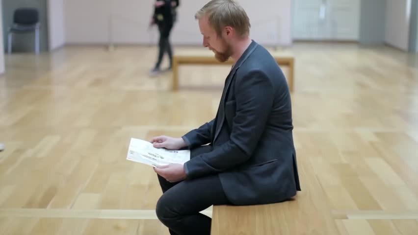 Man With a Booklet, Map Sits in the Picture Gallery