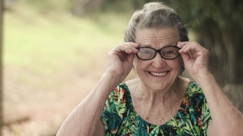 Joyful senior lady in glasses laughing